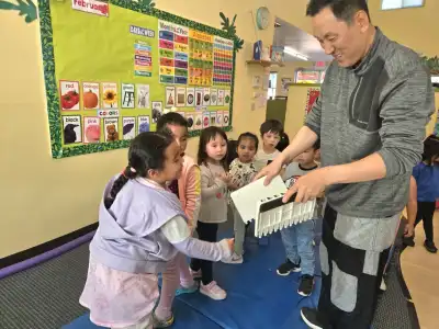 Child doing a Tae Kwon Do activity with the lecturer breaking a board at Newport Ave Preschool enrichment program