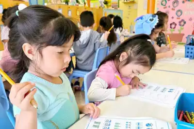 4-year-old Pre-K child at Newport Ave Preschool focused on a paper assignment during structured academic learning