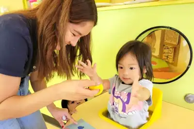 5-year-old child working with a teacher indoors at Newport Ave Preschool in a Private Kindergarten and Transitional Kindergarten program