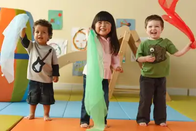 Children participating in dance and fitness enrichment at Newport Ave Preschool doing a group physical activity